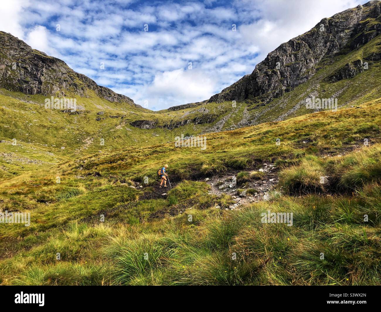 Walker dwarfed by the scale of the Scottish Highlands, Scotland - Smartphone Captured Stock Image