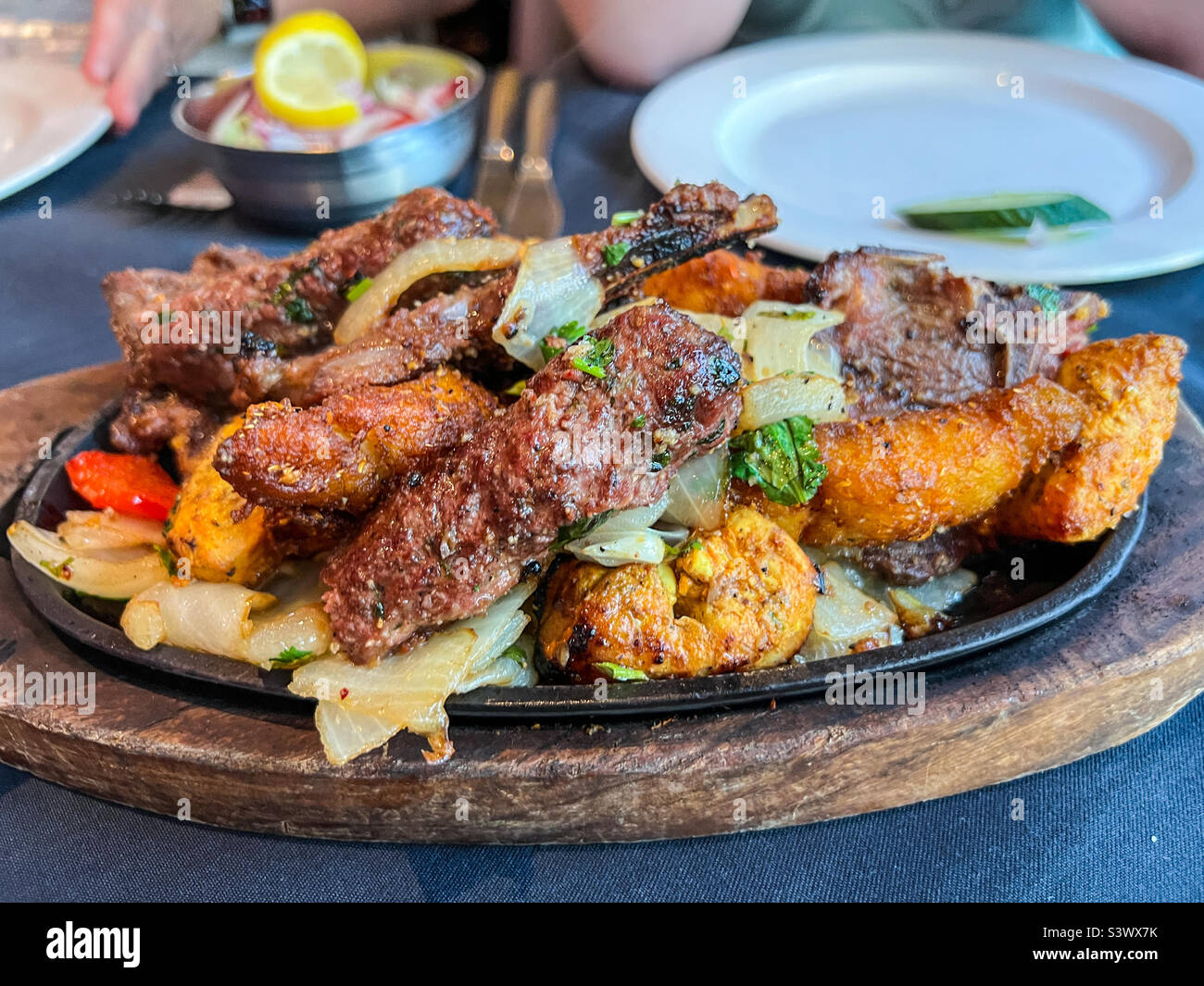 Indian mixed starter on a sizzling platter at an Indian restaurant Stock Photo
