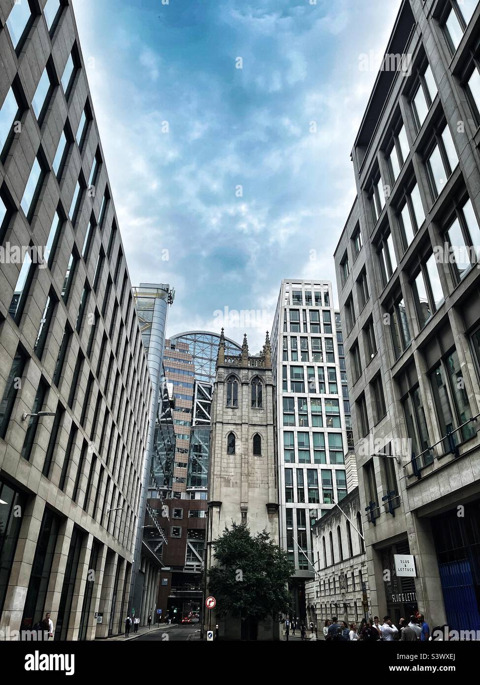 The tower of St Alban, Wood Street, London is surrounded by modern buildings leaving the mediaeval tower of the bombed Church alone. Grade II* listed building on 4 January 1950. - Smartphone Captured Stock Image