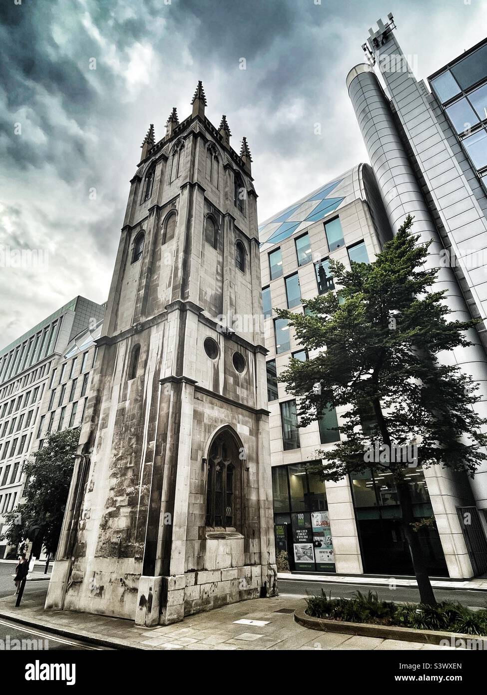 The tower of St Alban, Wood Street, London is surrounded by modern buildings leaving the mediaeval tower of the bombed Church alone. Grade II* listed building on 4 January 1950. - Smartphone Captured Stock Image