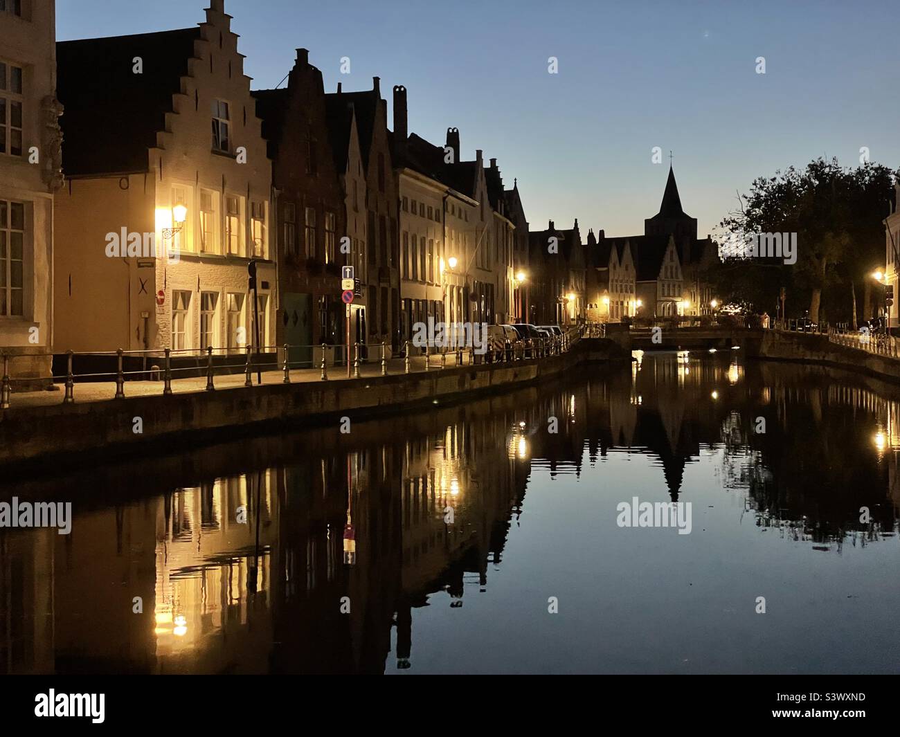 Reflections of Bruges in the canal at dusk, August. - Smartphone Captured Stock Image