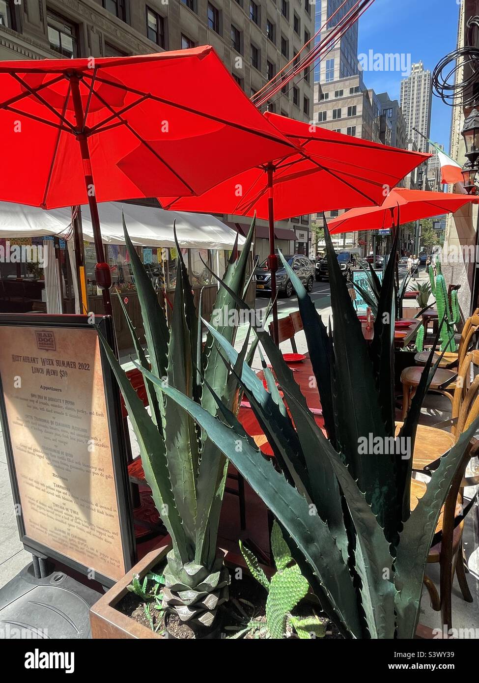 Red umbrellas for outdoor dining on a New York City street, USA - Smartphone Captured Stock Image