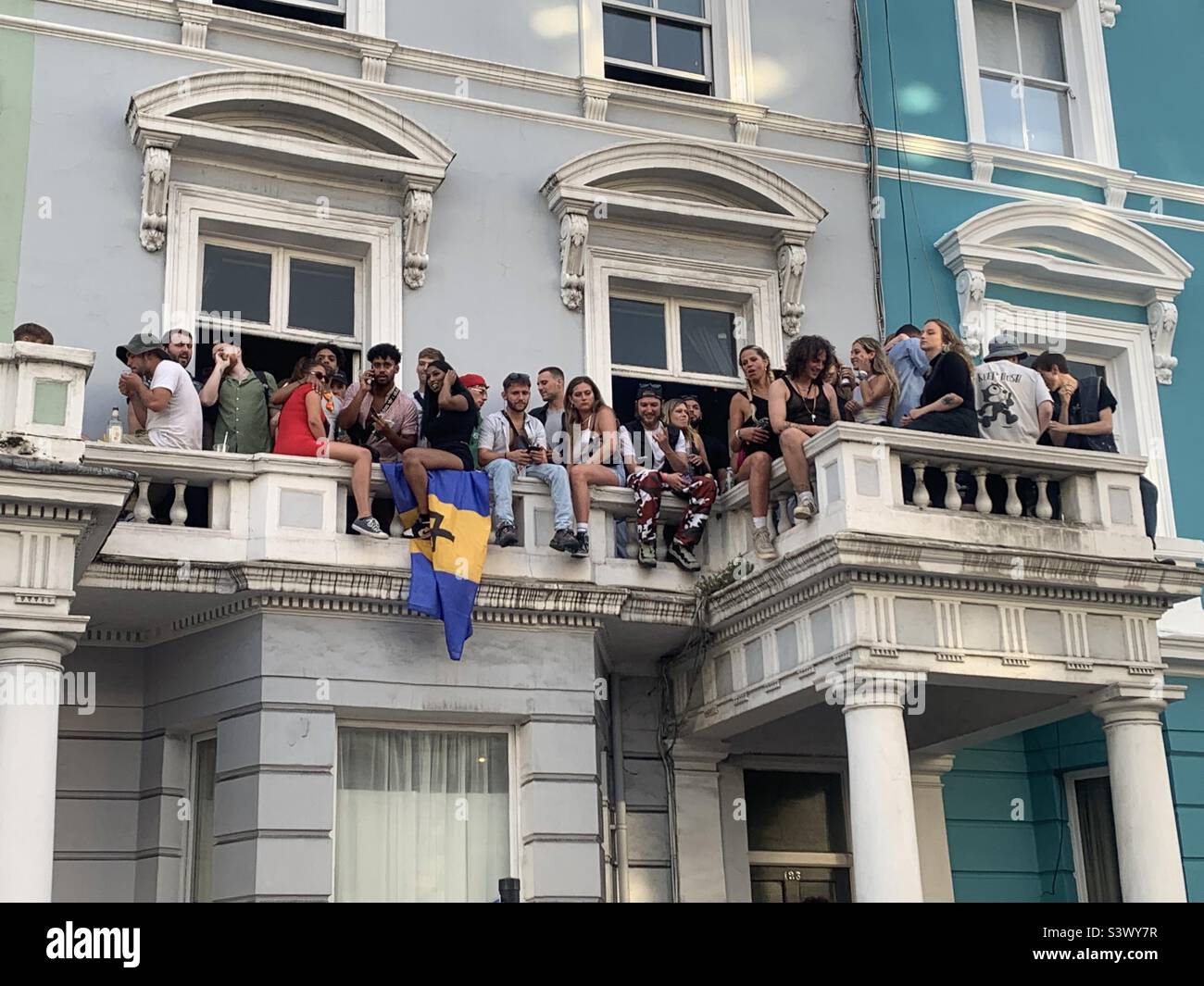 People sitting on balcony at Notting hill carnival London Stock Photo