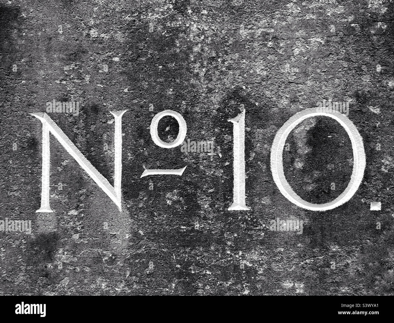 No. 10. Number 10. Number 10. Identification engraved into a stone block indicating the number of a house or building. Photo ©️ COLIN HOSKINS. Stock Photo