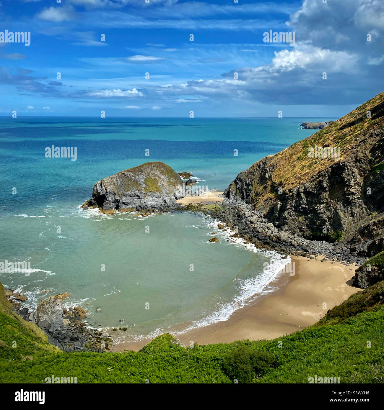 A secluded beach on the Ceredigion Coast Path 2km west from Llangrannog in Wales. This unspoiled cove can only be reached by boat or by climbing down a little cliff Stock Photo