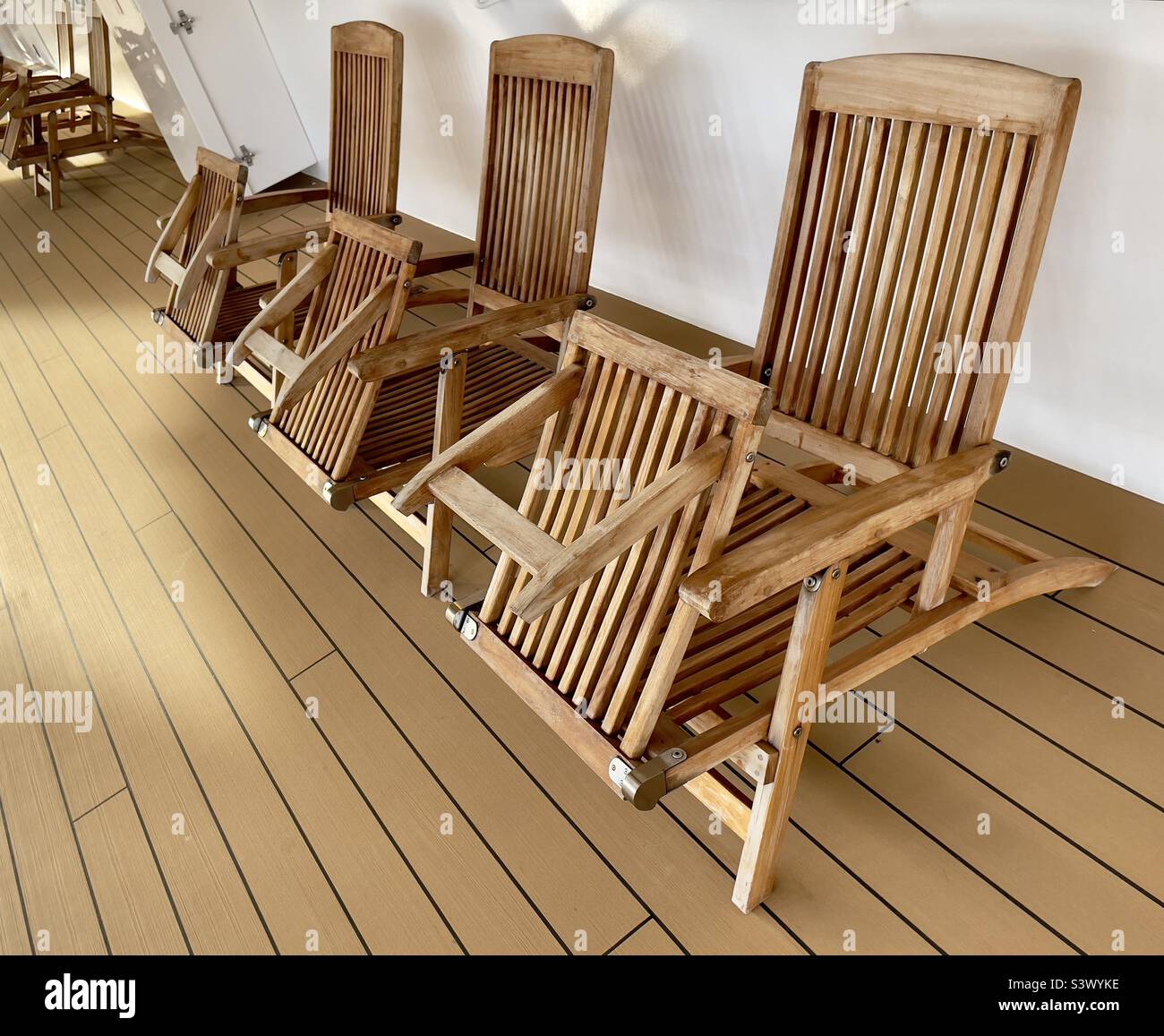 A row of steamer chairs on the promenade deck of a cruise liner. - Smartphone Captured Stock Image