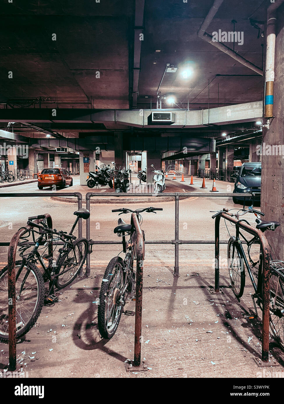 Bicycles at the cycle racks at the underground pick up and drop off area at Reading Railway Station in Berkshire, UK - Smartphone Captured Stock Image