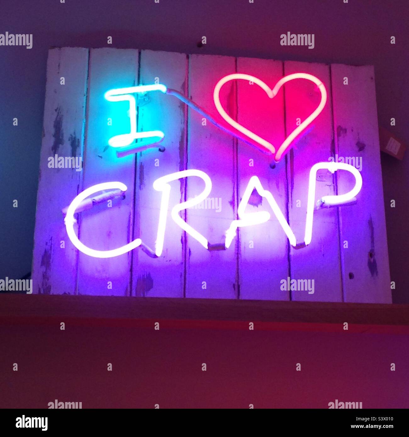 Neon art sign on sale in a shop in london the sign reads ‘I ❤️ crap’ Stock Photo