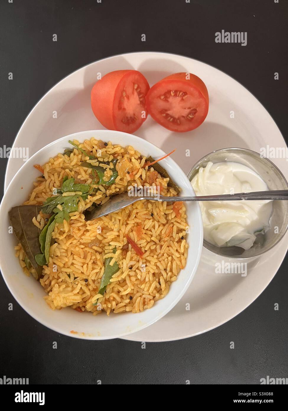 Tomato rice with onion yogurt Stock Photo Alamy