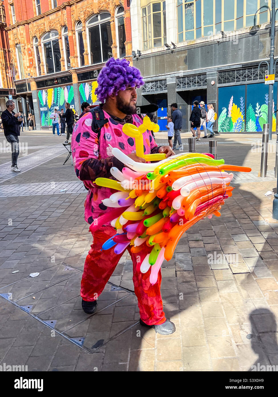 Street trader selling long balloons in Leeds city centre - Smartphone Captured Stock Image