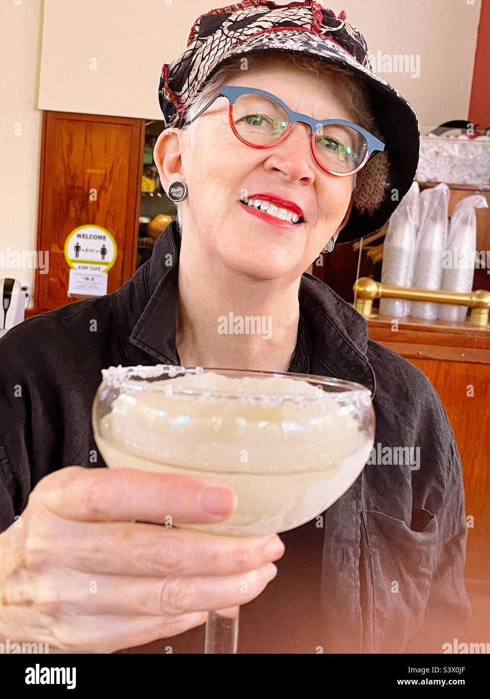 Fashionable senior woman enjoying a frozen margarita at El Rio grande Mexican restaurant, 2022, New York City, USA Stock Photo