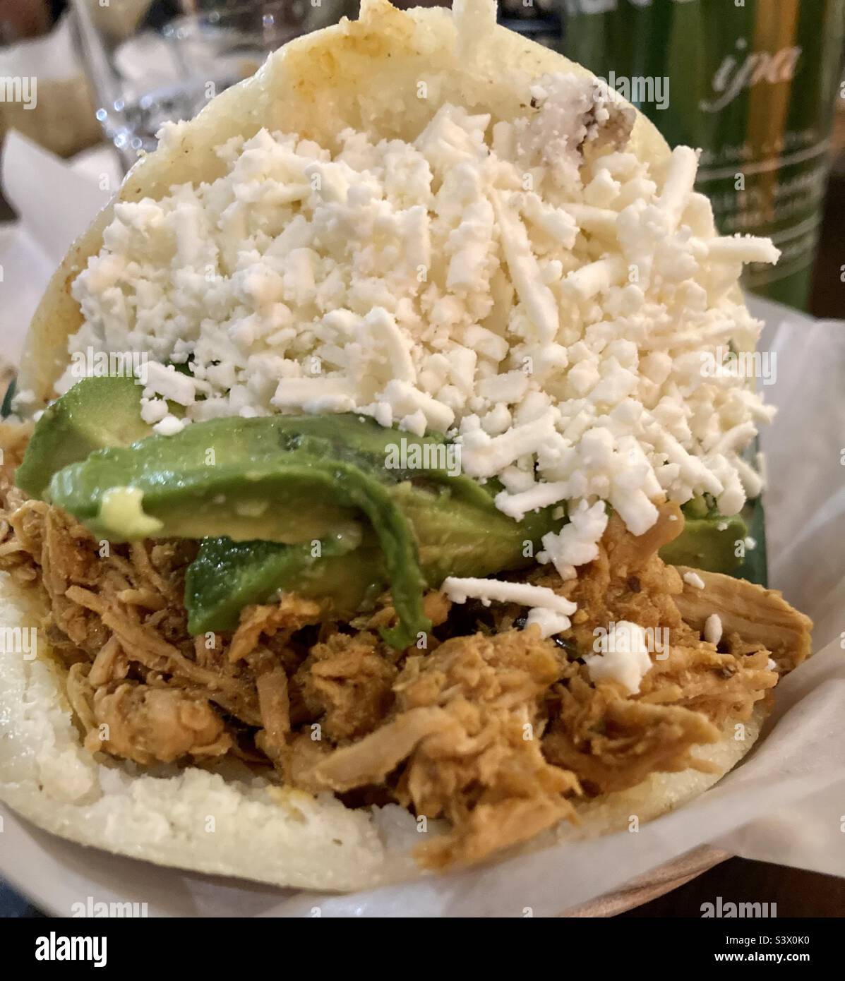 Venezuelan arepa stuffed with pulled chicken, avocado and feta cheese. - Smartphone Captured Stock Image