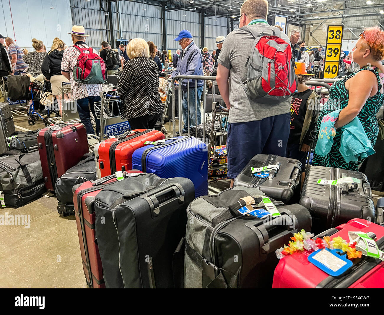 People queuing at Southampton ports luggage bay at city cruise terminal Stock Photo