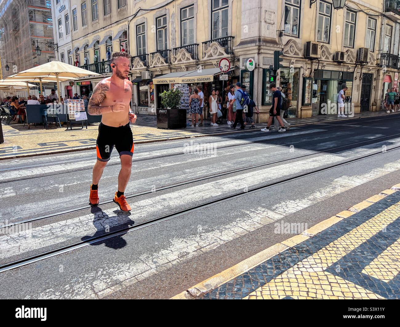 Keep fit athlete running in street in Lisbon Portugal - Smartphone Captured Stock Image