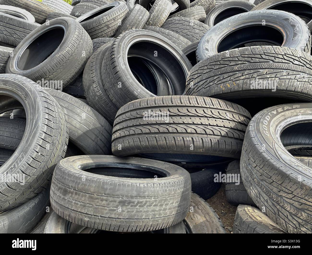 Pile of old and used tires behind an auto shop in West Valley City, Utah, USA. Though a mundane subject, this caught my eye with all the shape and texture. I think it makes an interesting abstract. - Smartphone Captured Stock Image