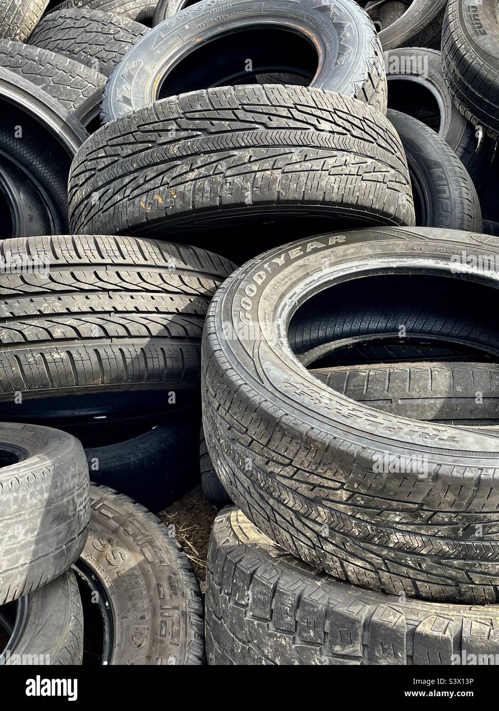 Pile of old and used tires behind an auto shop in West Valley City, Utah, USA. Though a mundane subject, this caught my eye with all the shape and texture. I think it makes an interesting abstract. - Smartphone Captured Stock Image