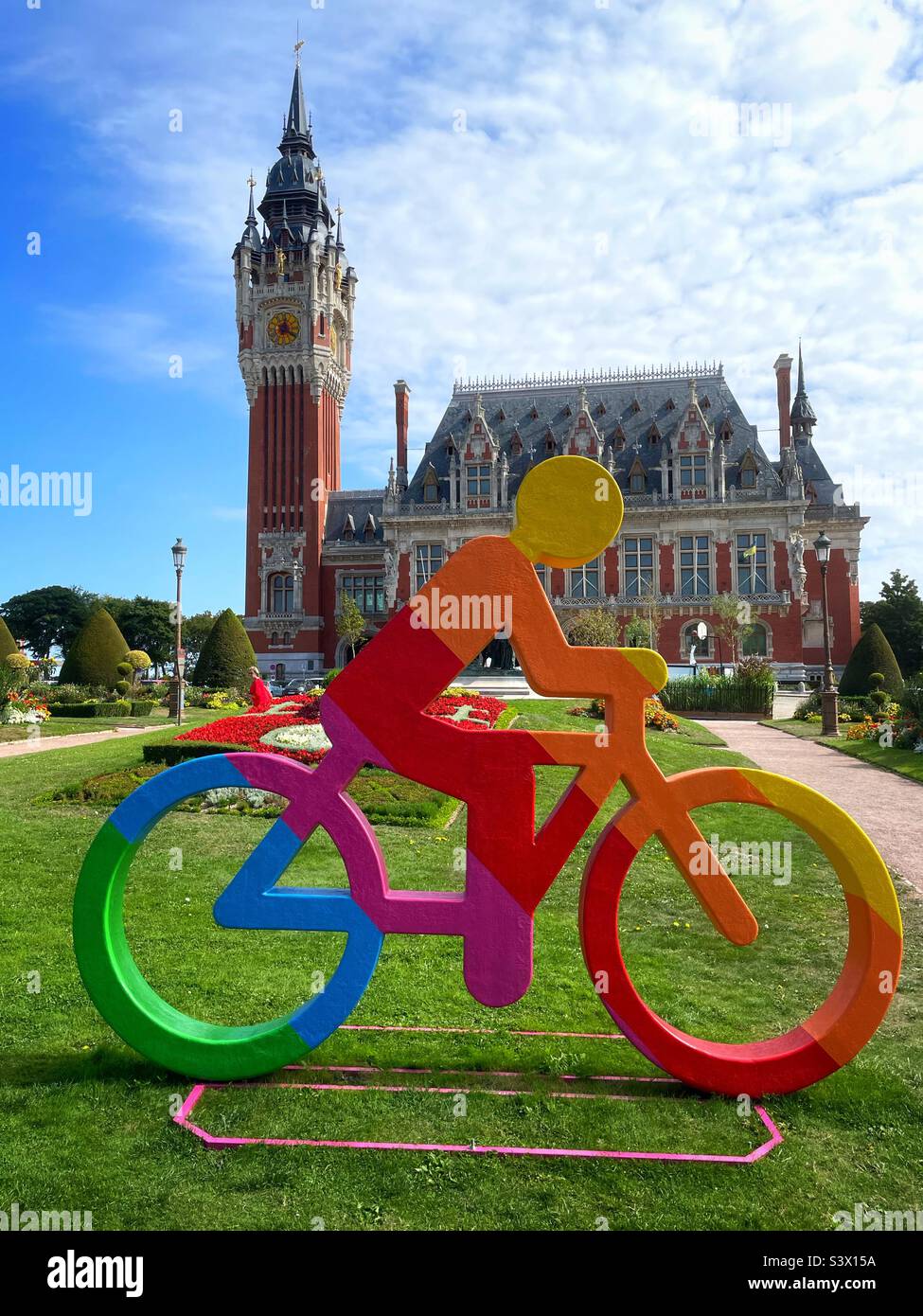 Cyclist in LGBTQ+ colours outside the town hall in Calais, France, August 2022. - Smartphone Captured Stock Image