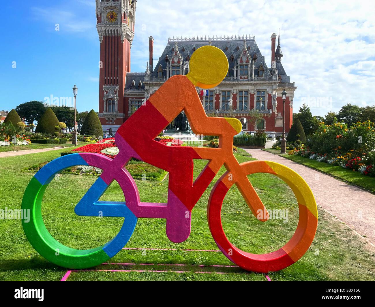 Colourful cyclist model in LGBTQ+ colours outside the Town Gall in Calais, France, August 2022 - Smartphone Captured Stock Image