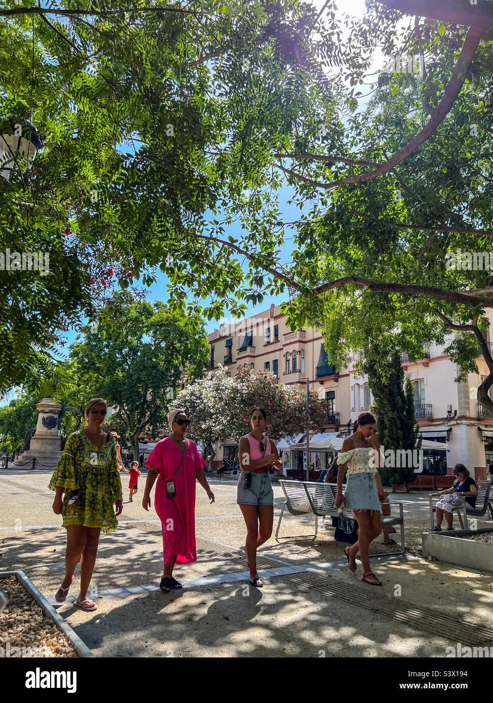 Women walking in the Paseo de Vara de Ray precinct in leafy Ibiza in the Balearic Islands Spain Stock Photo