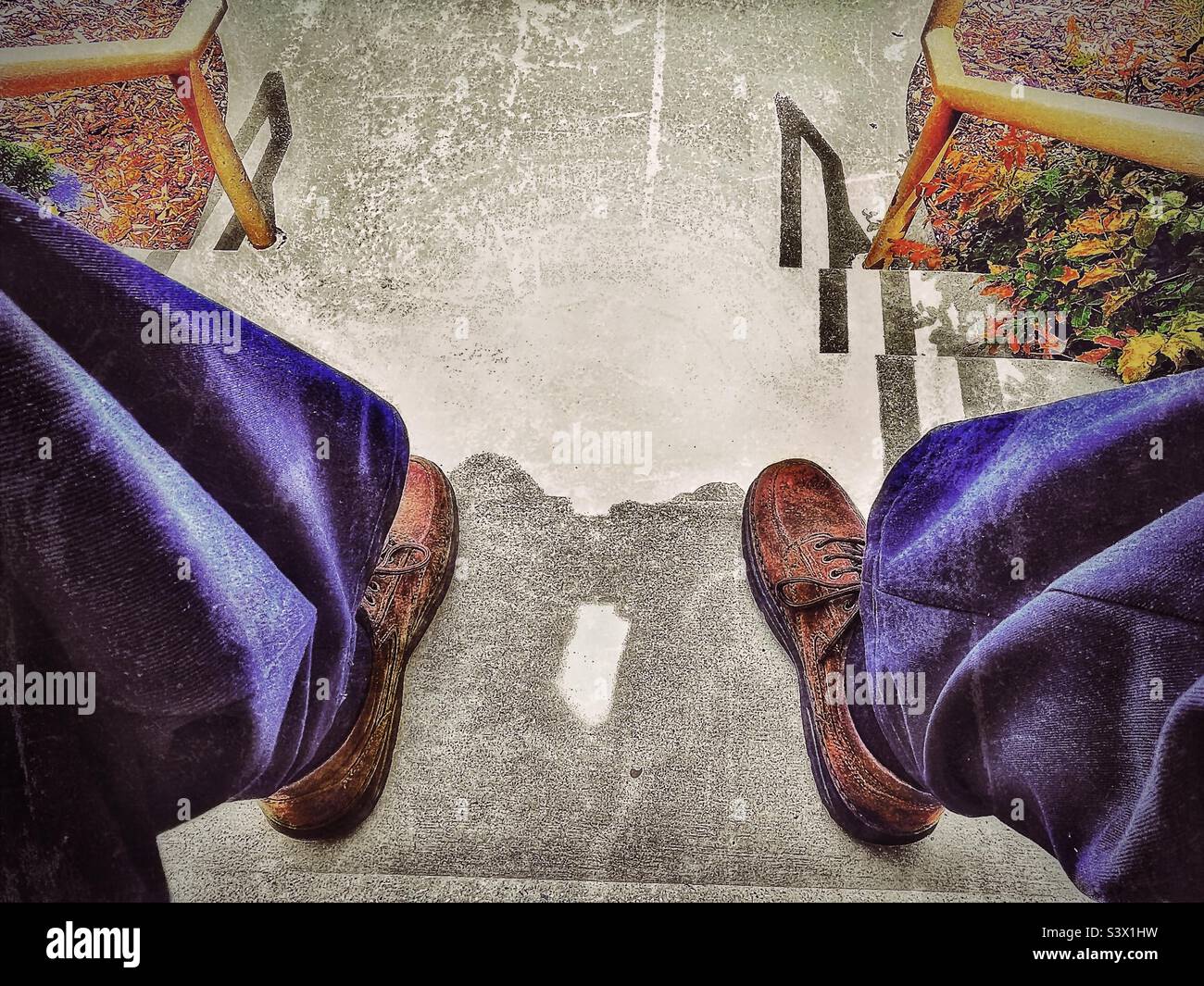 Man in Sunday dress sitting on outdoor steps at a local church in Utah, USA. Casually relaxing on a sunny day, image is shot while sitting looking down the steps between the man’s knees-Perspective! - Smartphone Captured Stock Image