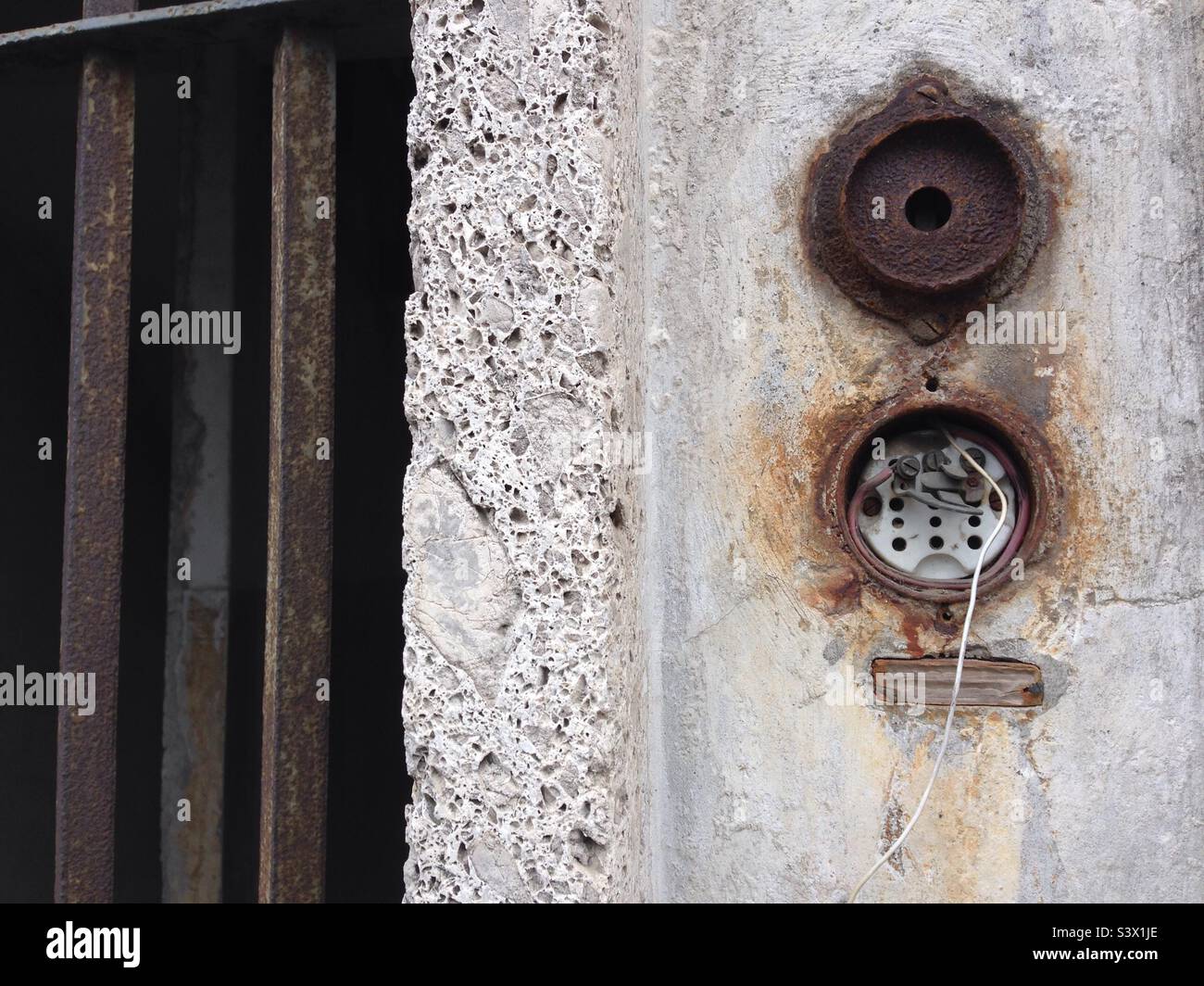 Old broken intercom on an entrance gate in Italy. - Smartphone Captured Stock Image