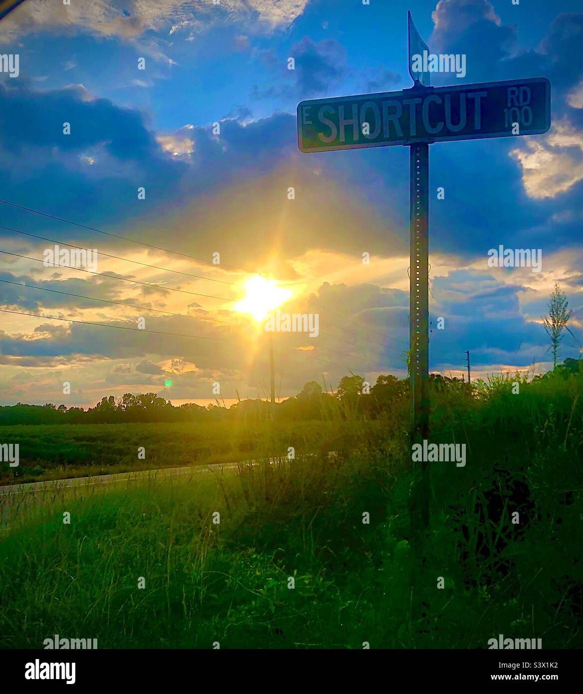 Southern country road as the sun is making its way to the horizon to sleep - Smartphone Captured Stock Image