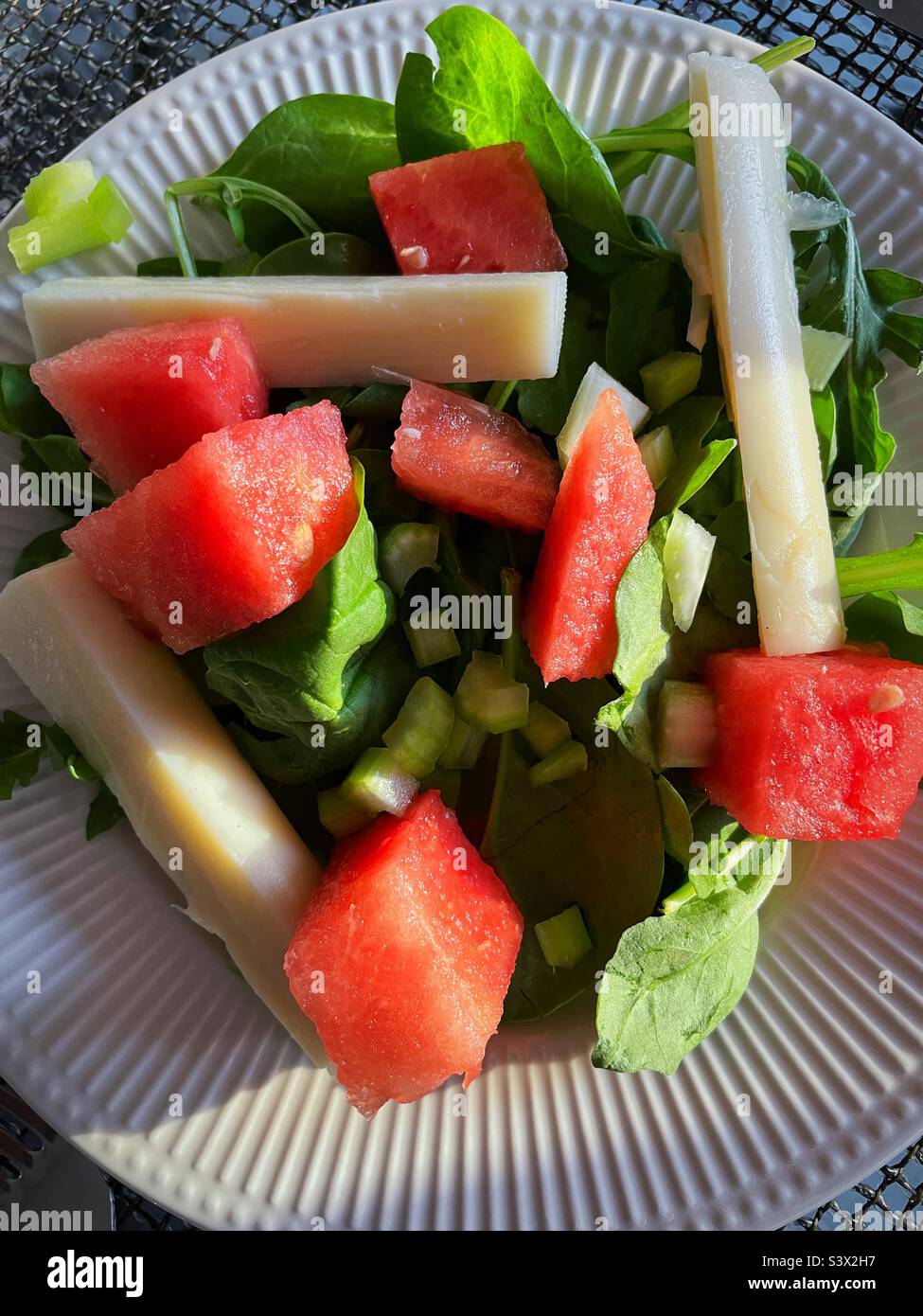 Close-up of a spinach salad topped with red watermelon chunks and hearts of palm, 2022, USA Stock Photo