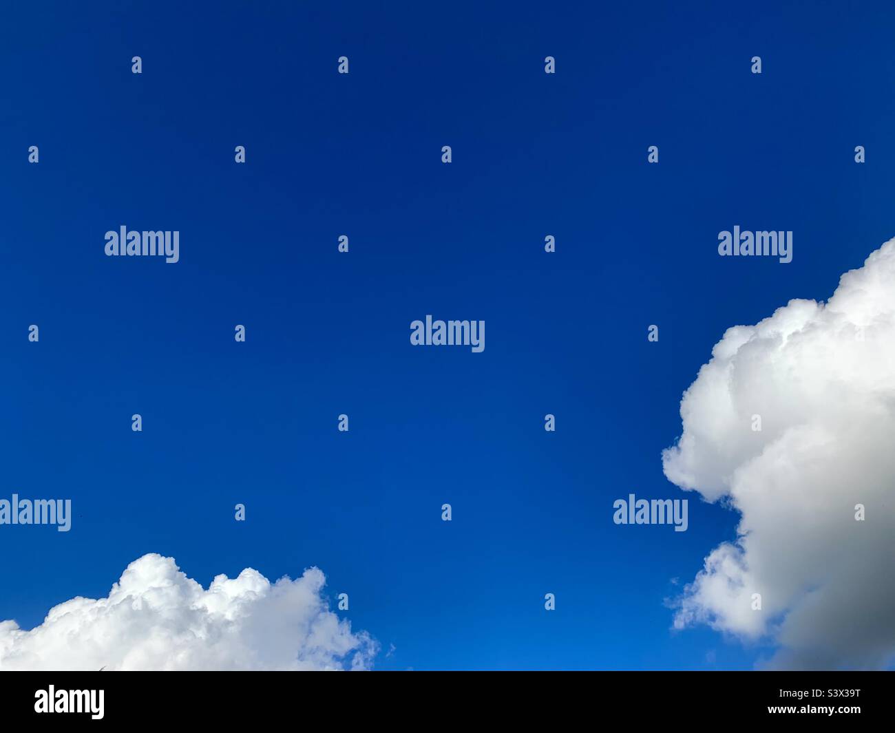 Fluffy white clouds and blue sky - Smartphone Captured Stock Image