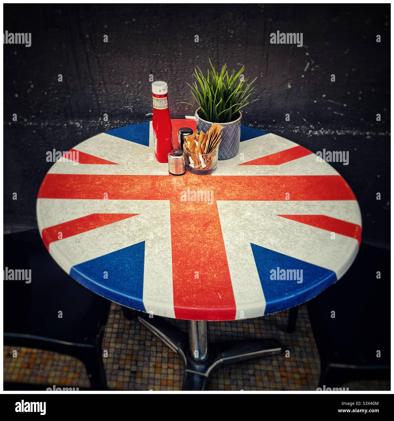 Round cafe table, decorated with a Union Jack design - Smartphone Captured Stock Image