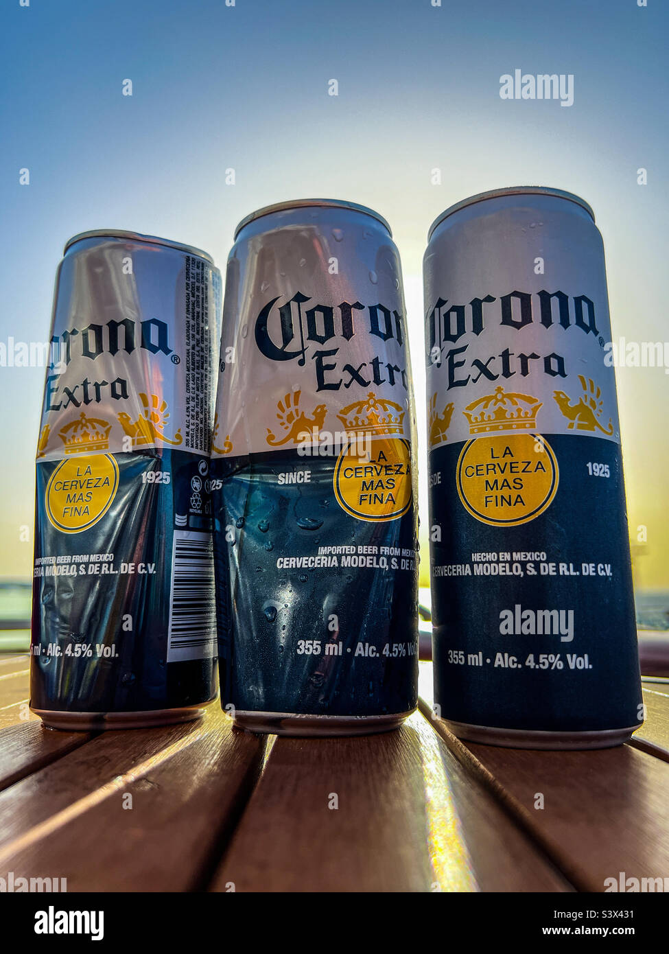 Three cans of Corona Extra lager Stock Photo