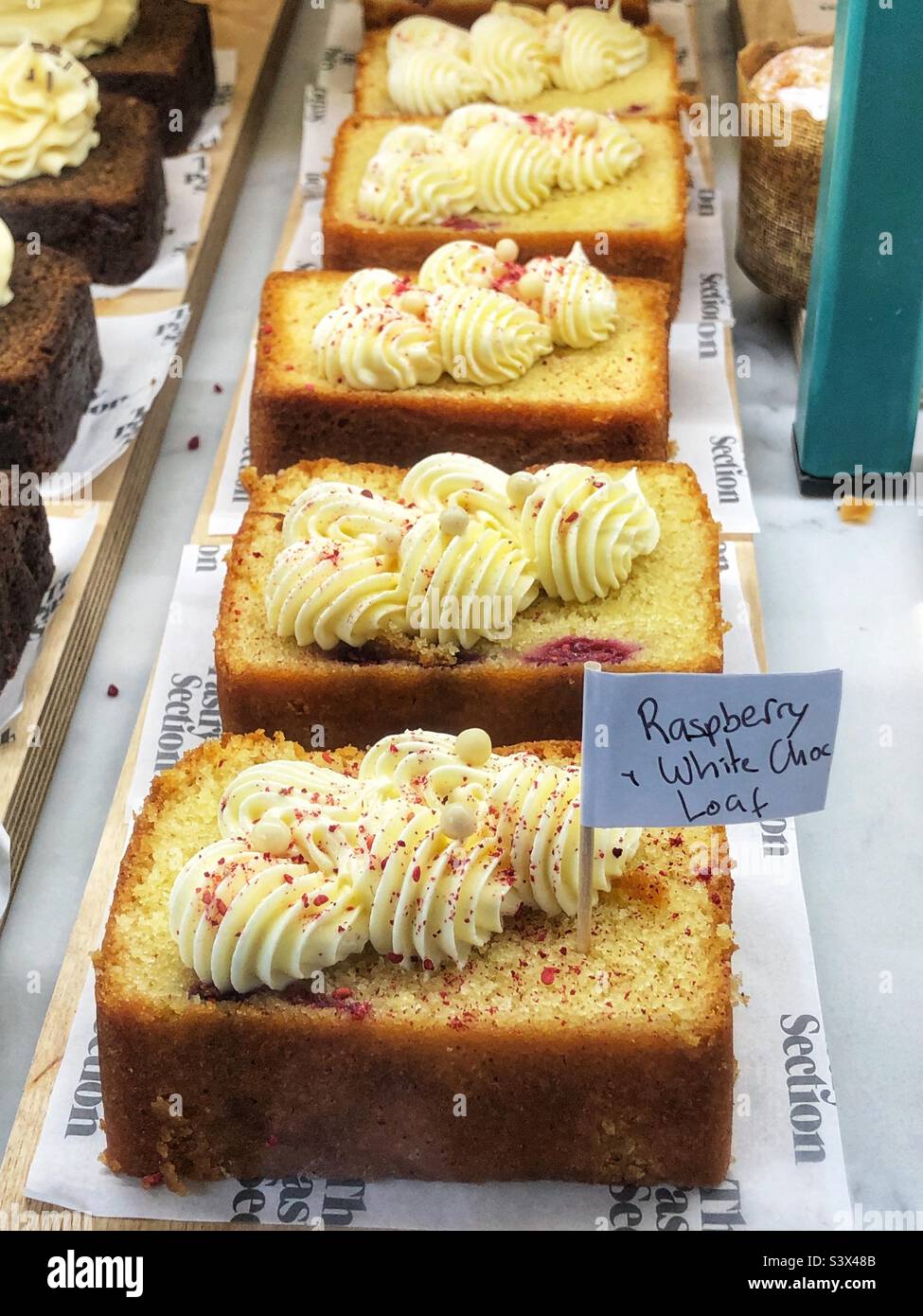 Cake Raspberry and white chocolate loaf in bakery window - Smartphone Captured Stock Image