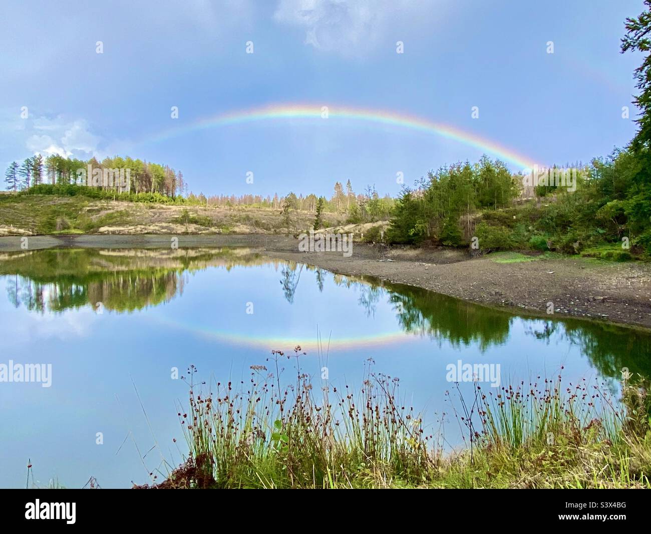 Reflection of the rainbow in the lake Stock Photo Alamy
