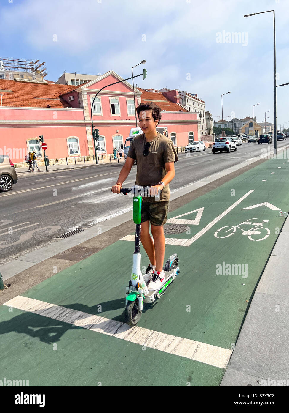 Young man riding his electric scooter in Lisbon Portugal Stock Photo
