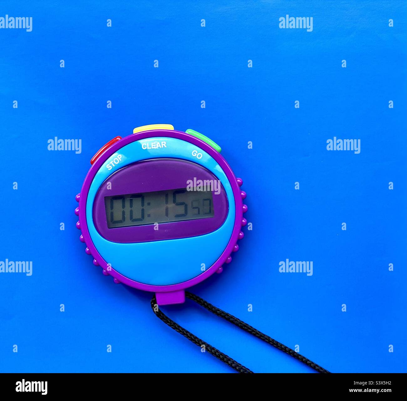Child’s stopwatch on a blue background Stock Photo