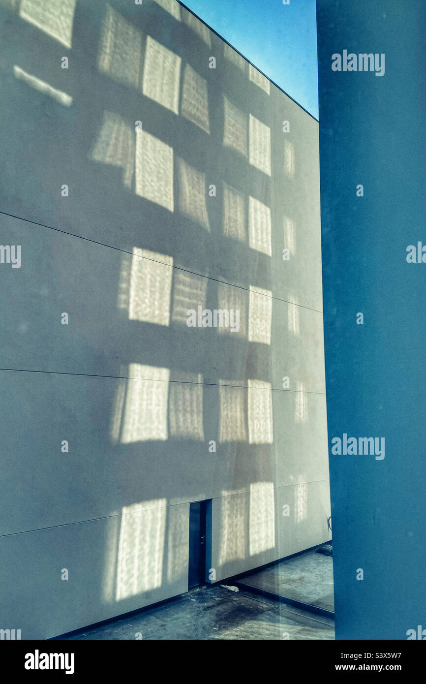 Reflections of windows on concrete wall - Smartphone Captured Stock Image