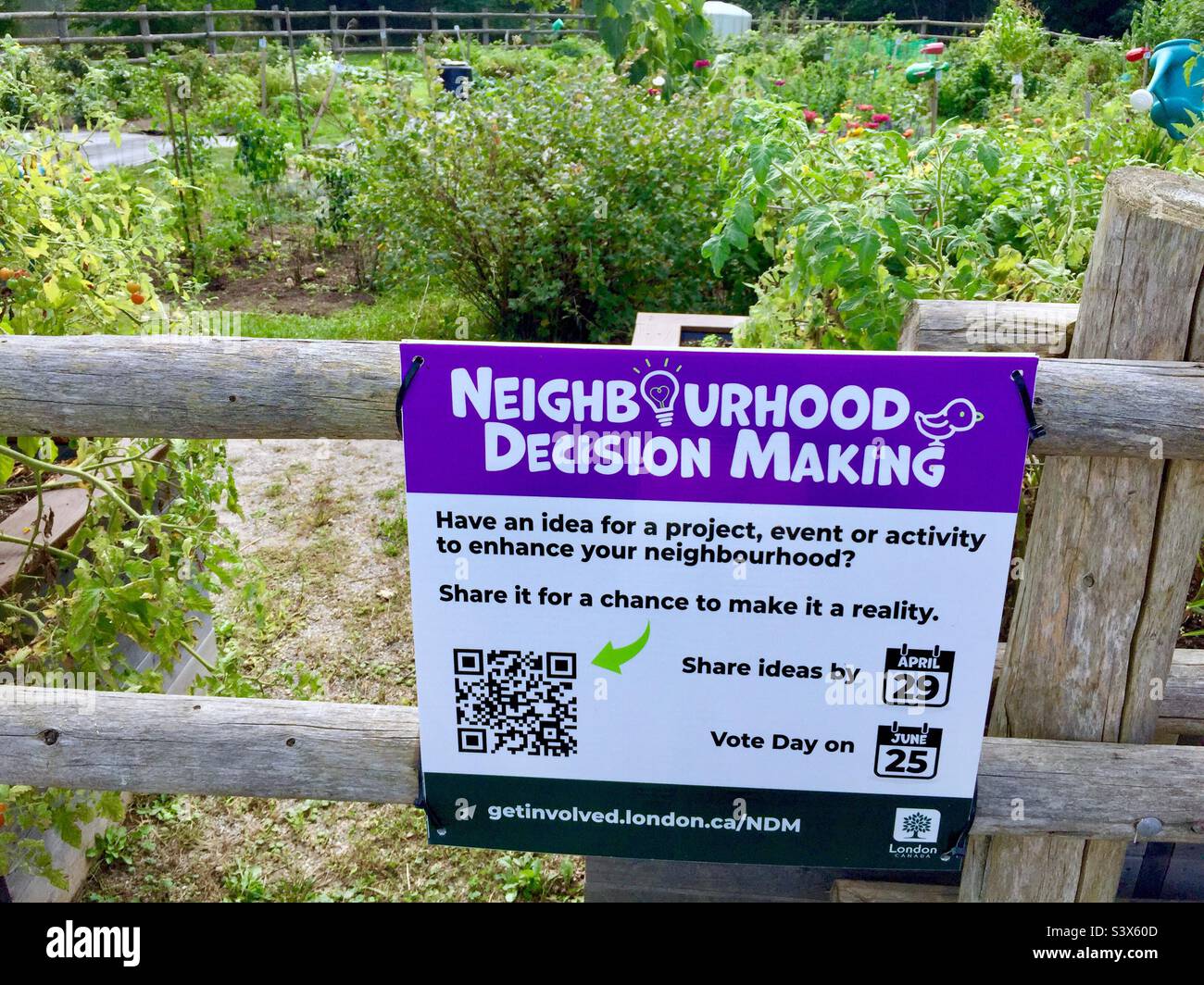 Grassroots democracy. Sign outside a community garden. Decentralized decision making. Participatory. Stock Photo