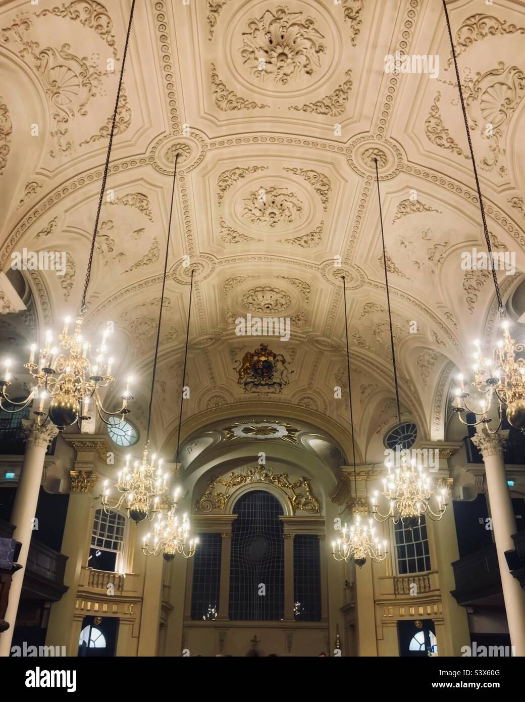 Inside St Martin in the Fields church, Trafalgar Square, London with candelabra lit down the aisle - Smartphone Captured Stock Image