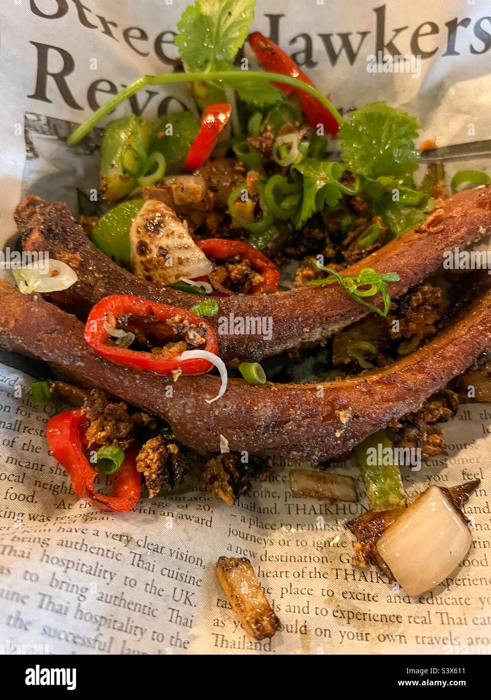 Salt and pepper ribs in newspaper Stock Photo