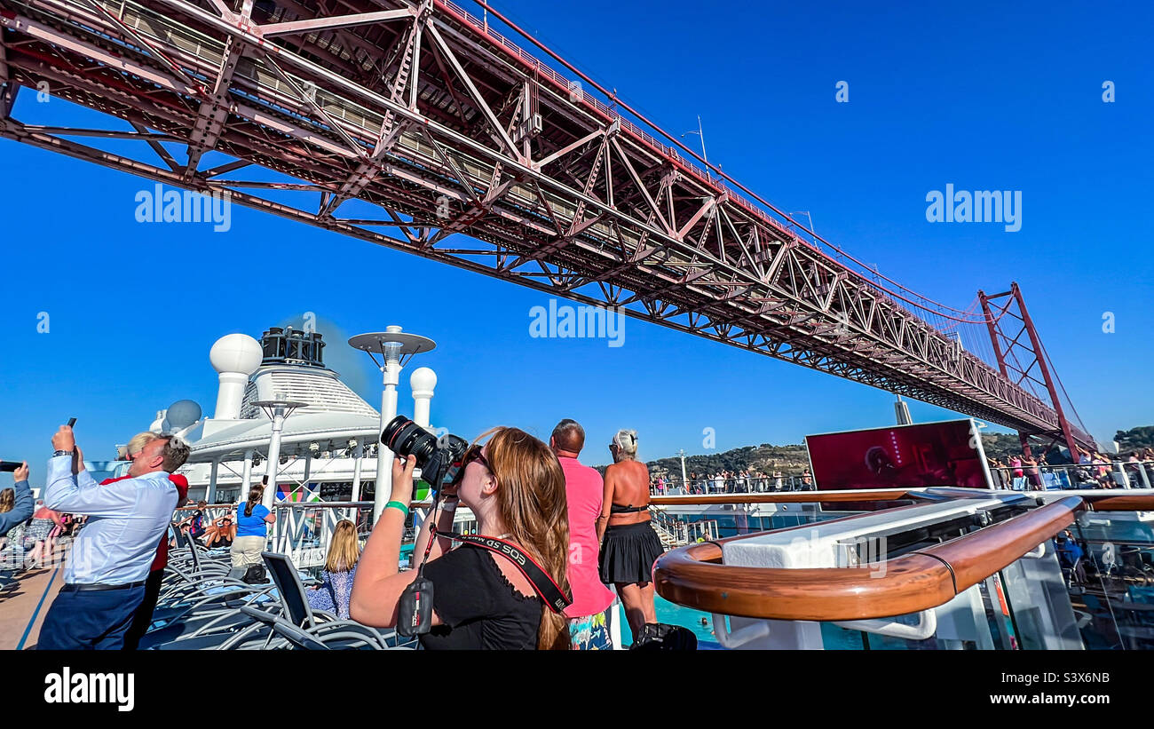 Cruise ship passing under the Ponte 25 de Abril bridge on the river Tagus in Lisbon Portugal Stock Photo