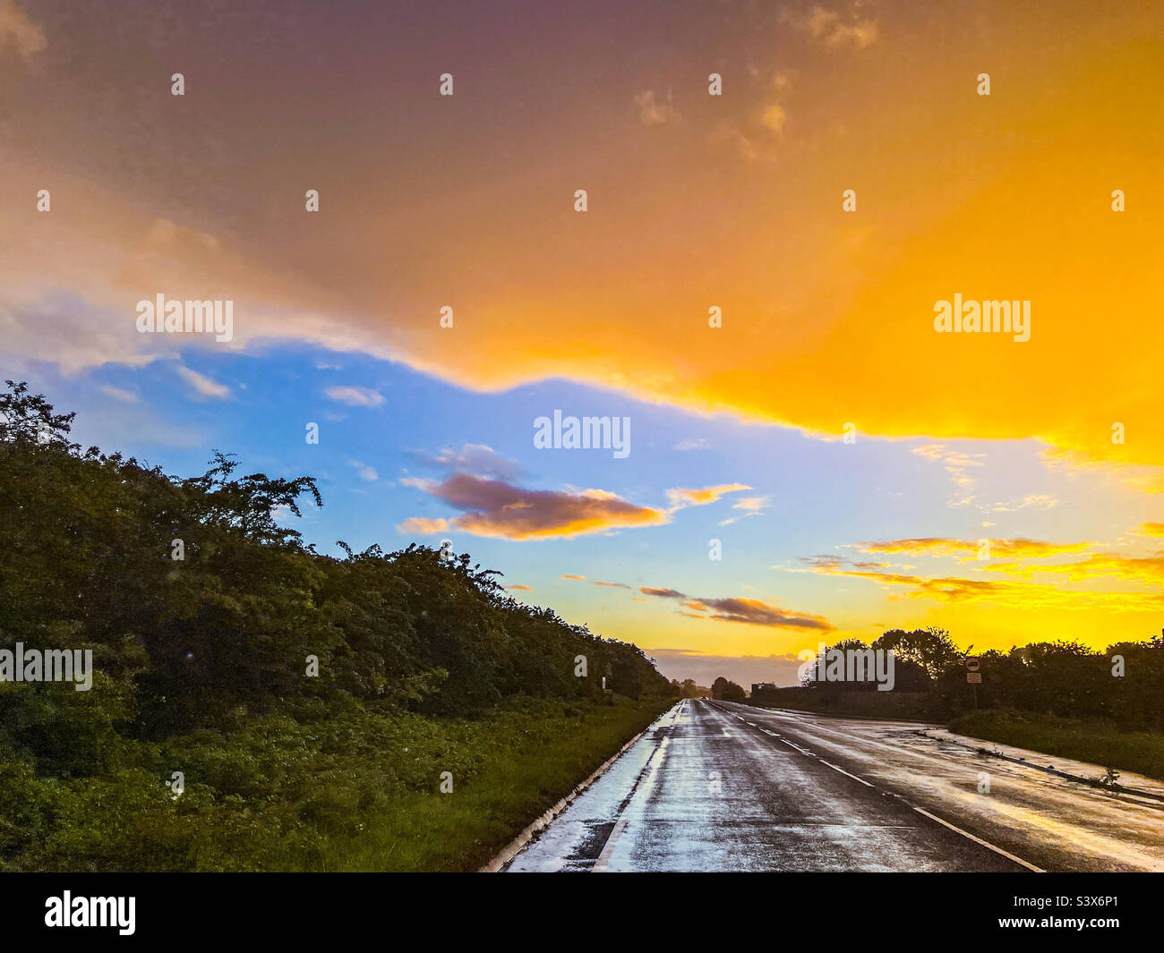 Vivid orange sunset on a country road in East Riding of Yorkshire - Smartphone Captured Stock Image