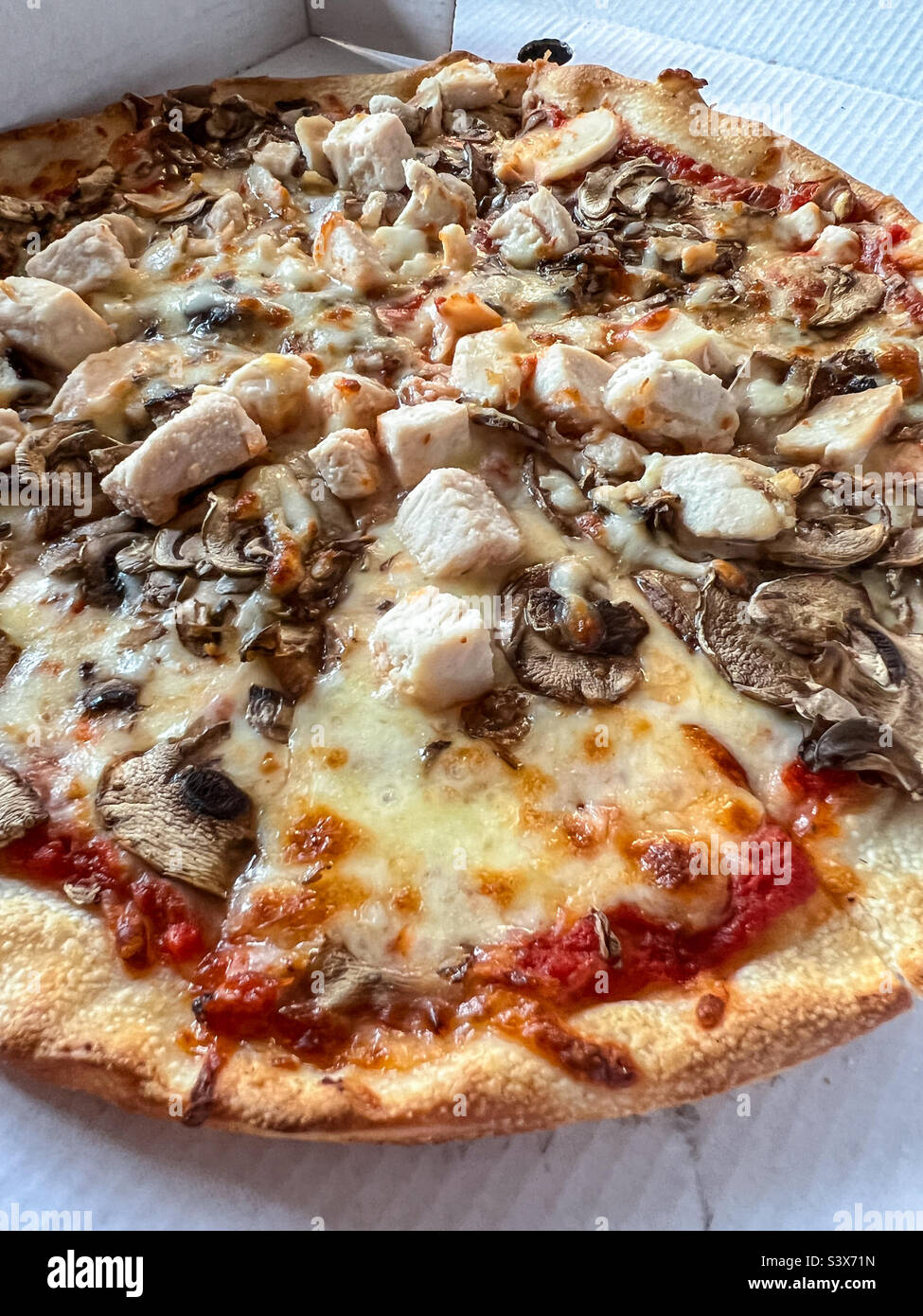 Chicken and mushroom pizza takeaway Stock Photo