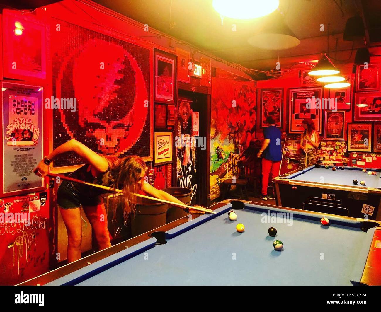 A woman plays pool in a rock bar in Denver - Smartphone Captured Stock Image