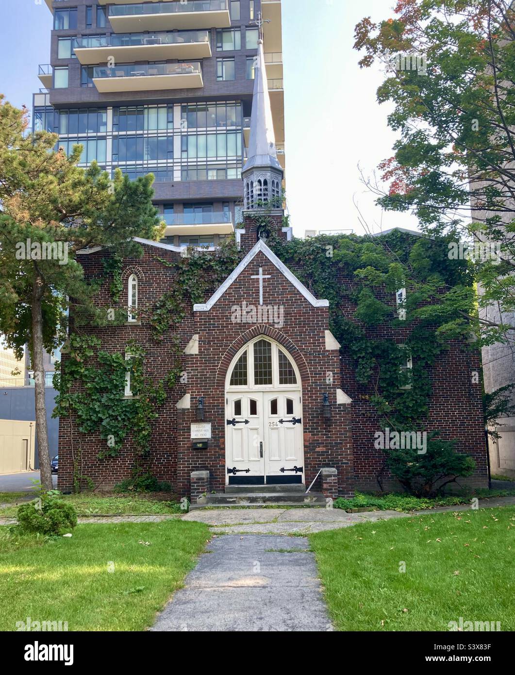 Eglise Christ-Roi church tucked between large apartment buildings. - Smartphone Captured Stock Image