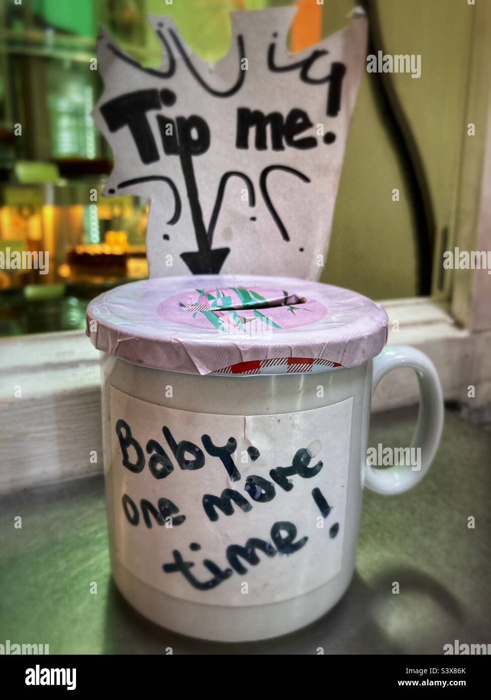 Tipping jar saying tip me Baby one More Time - Smartphone Captured Stock Image