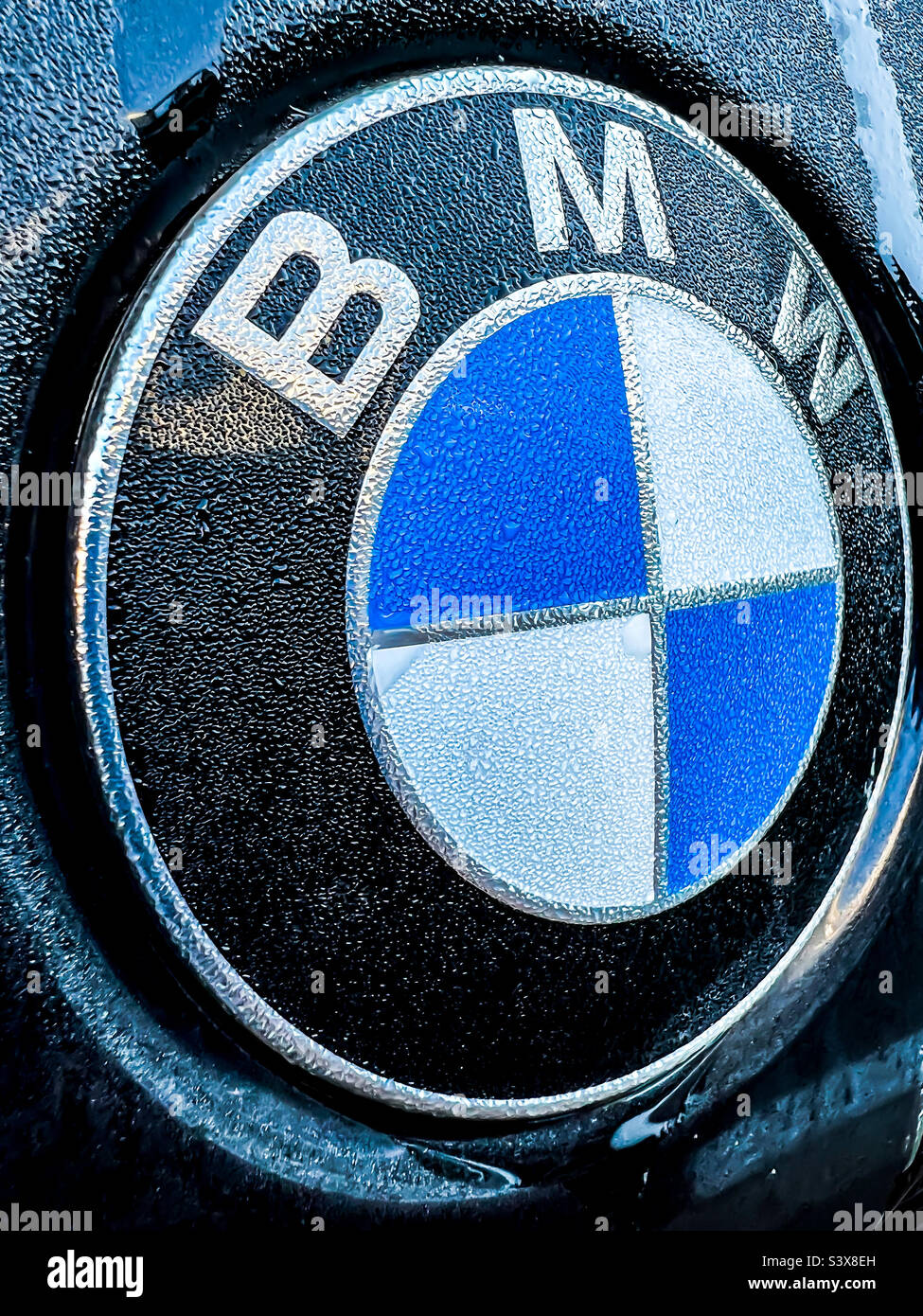Rain condensation on a BMW logo on a cold autumn morning Stock Photo