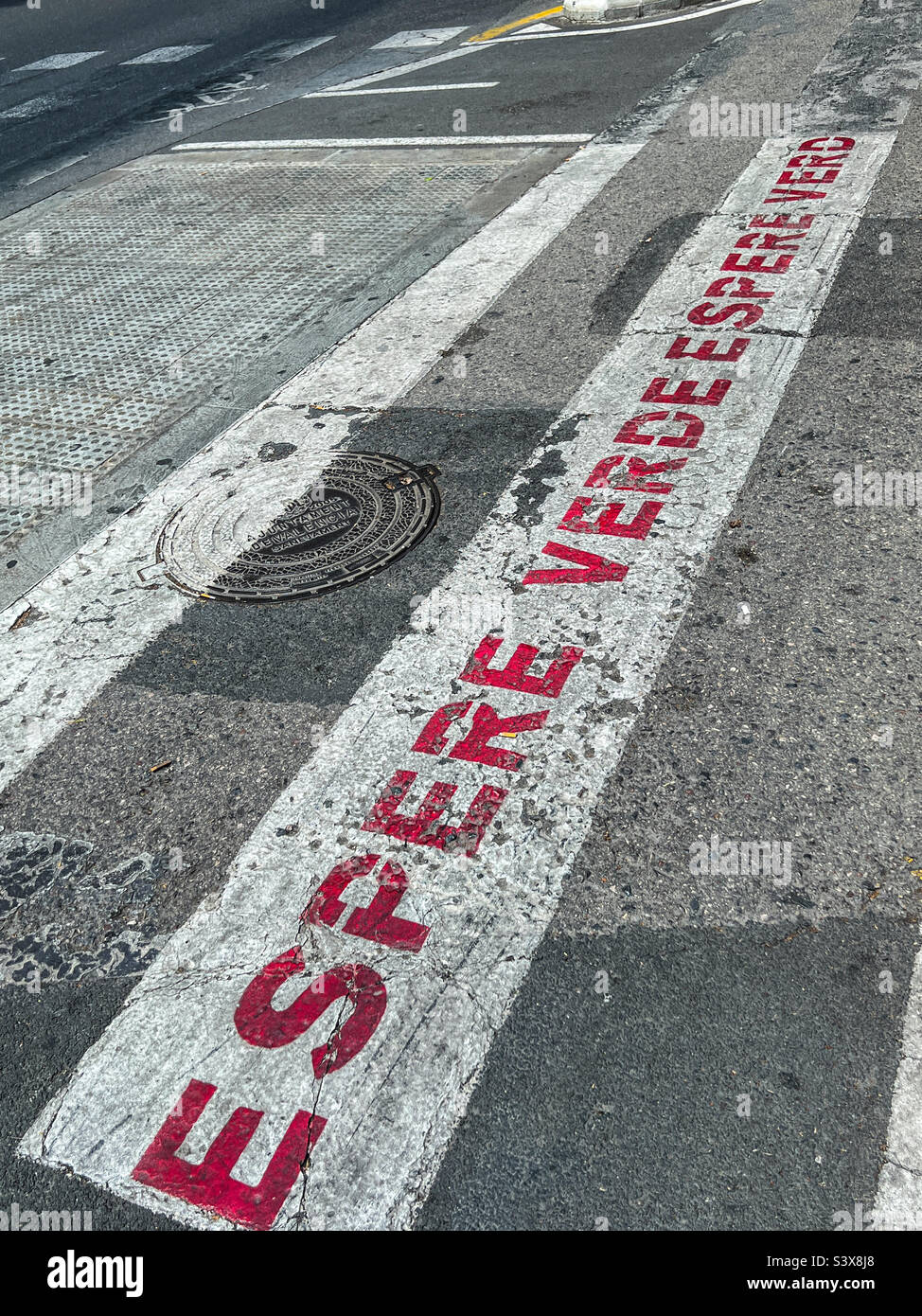 Wait Green in Spanish Road safety markings in Valencia Spain Stock Photo