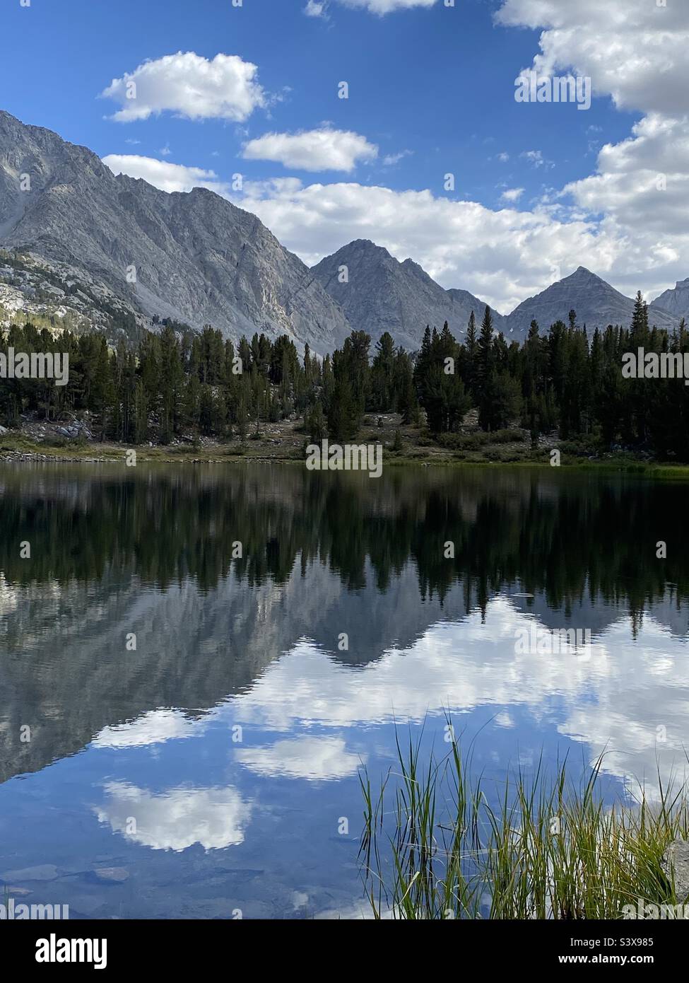 Reflection of the High Sierra in a lake in the rock creek drainage of California Stock Photo