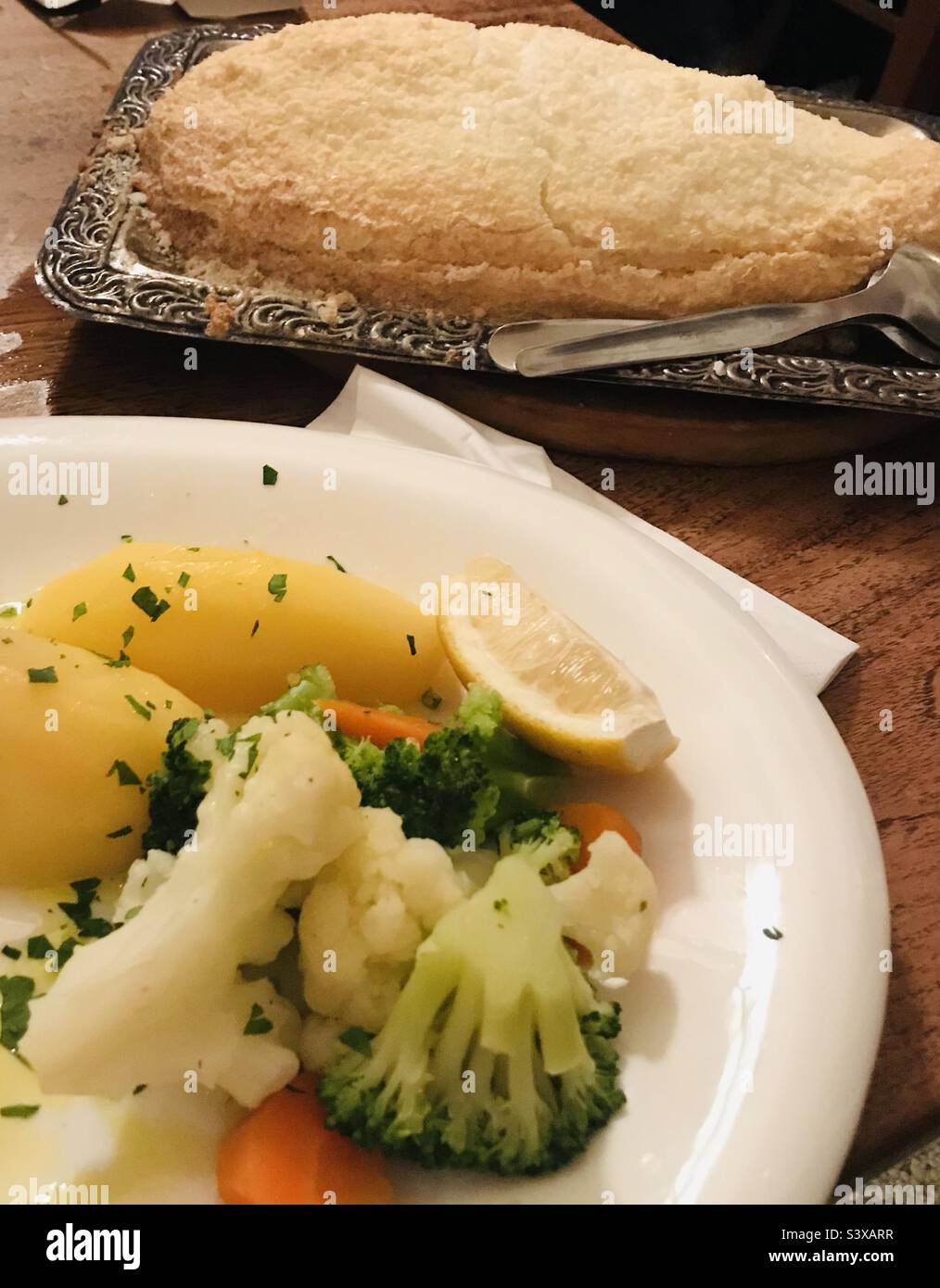 Traditional portuguese dish, fish in salt crust with potatoes and
