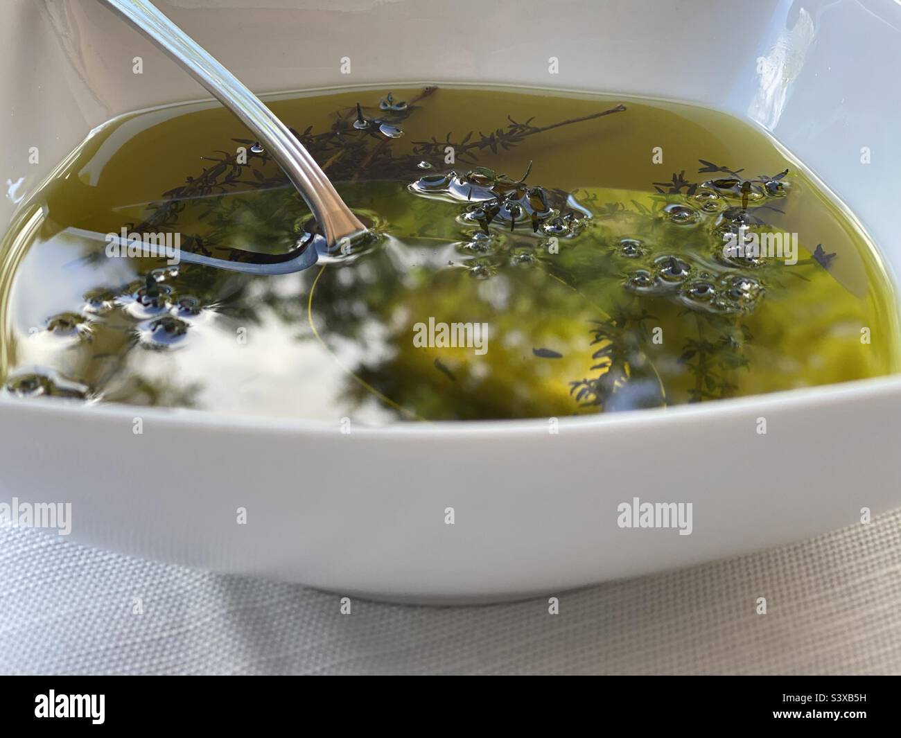 Olive oil with herbs. Grosseto, Italy. September 2022. - Smartphone Captured Stock Image