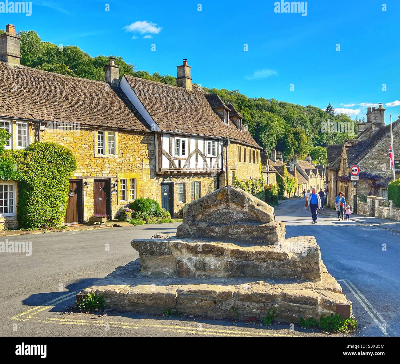 Centre of The Village of Castle Combe in the Cotswolds, Wiltshire looking down the street past the stone steps Stock Photo